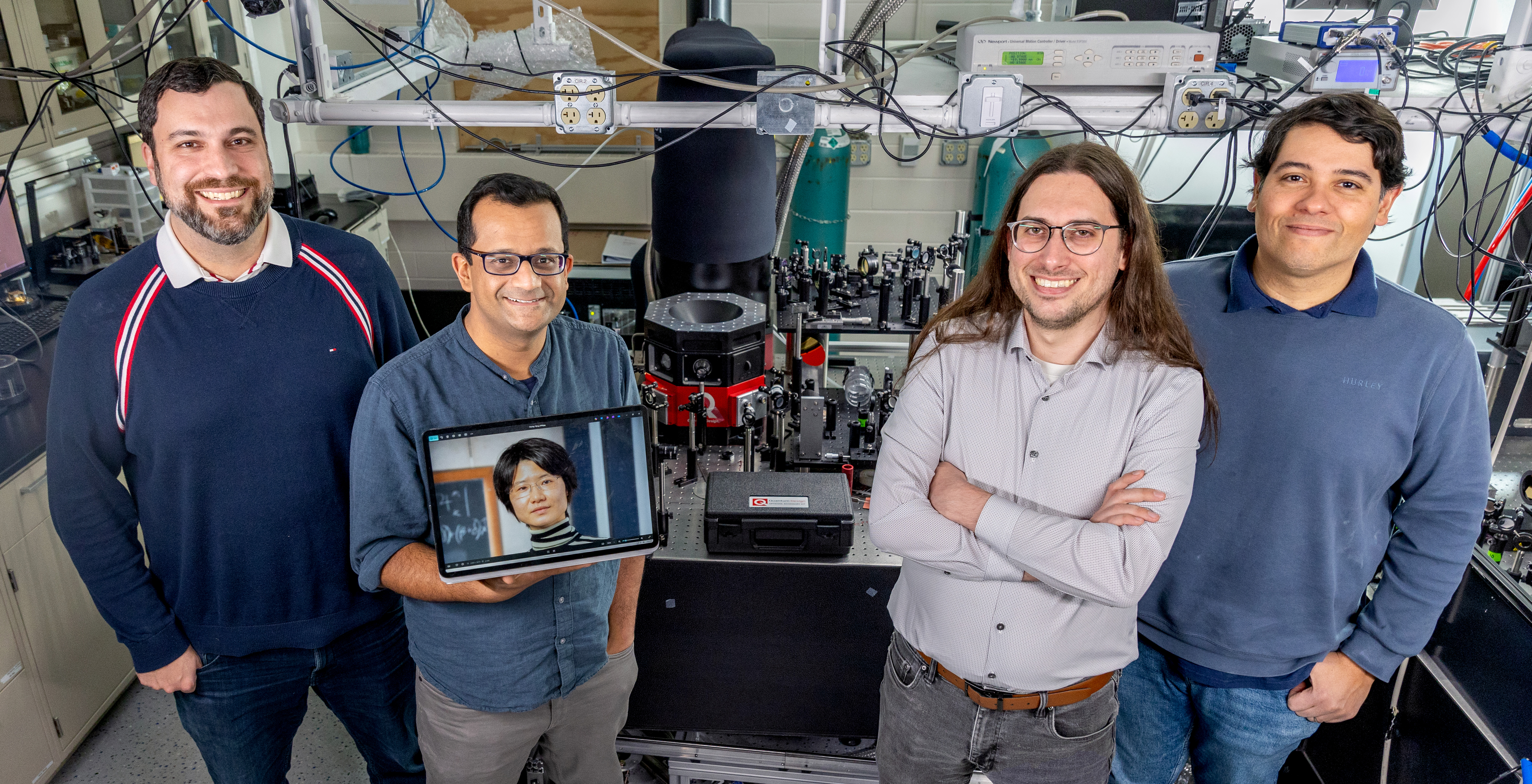 Members of Mahmood's lab standing in his laboratory.