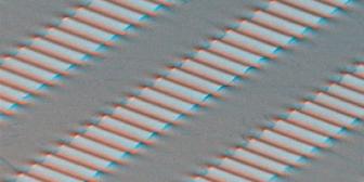 Scanning electron micrograph of 'wavy' single crystal silicon ribbons on an elastomeric substrate. This form of silicon has the unusual property that it is fully stretchable, with mechanics similar to an accordion bellows. 