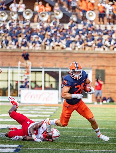 Fred Zwicky/U of I Public Affairs<br />Illinois running back Mike Epstein (26) breaks a tackle as the Fighting Illini Football team defeat the Nebraska Cornhuskers 30-22 at Memorial Stadium on Oct. 29. One of Statt's research efforts may help improve football players' helmets by helping them help absorb impact energy.