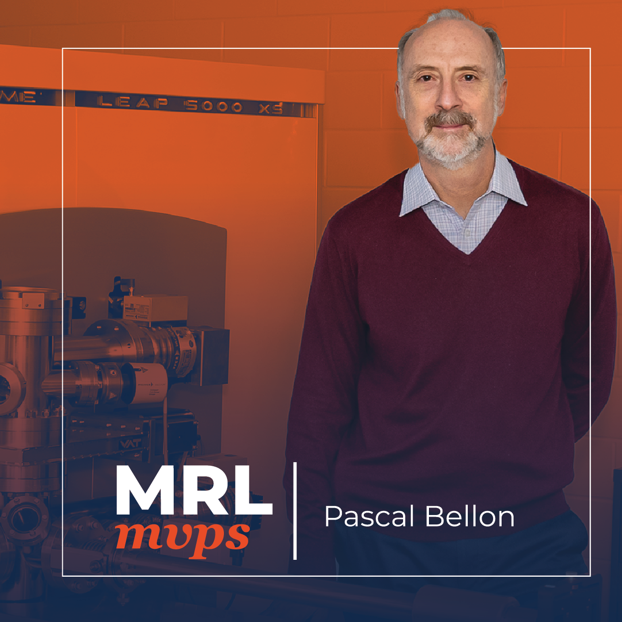 Photo shows a man standing next to scientific equipment